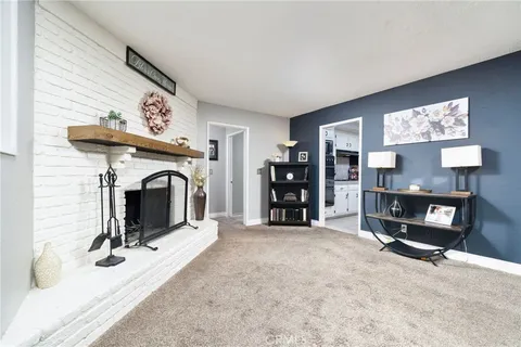 a living room with furniture a rug and a flat screen tv