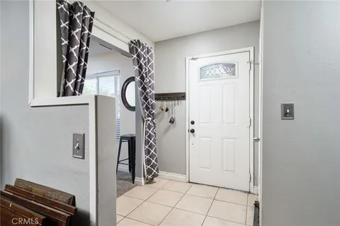 a kitchen with stainless steel appliances granite countertop a refrigerator a stove a sink and white cabinets