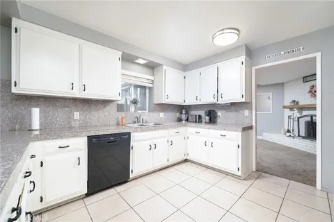 a kitchen with a sink window and cabinets