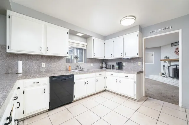 a kitchen with a sink window and cabinets