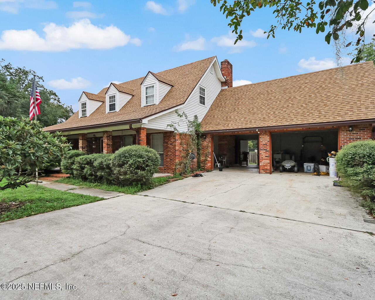 a front view of a house with a yard and a garage