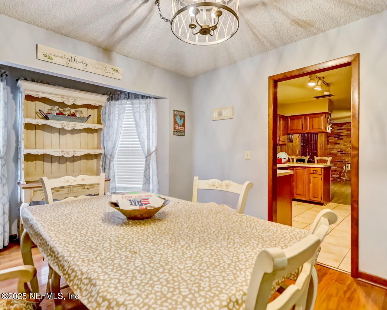 43059 Pearl Lane Callahan, FL 32011 - Photo 12 of 42 a bedroom with a table chairs and a large mirror