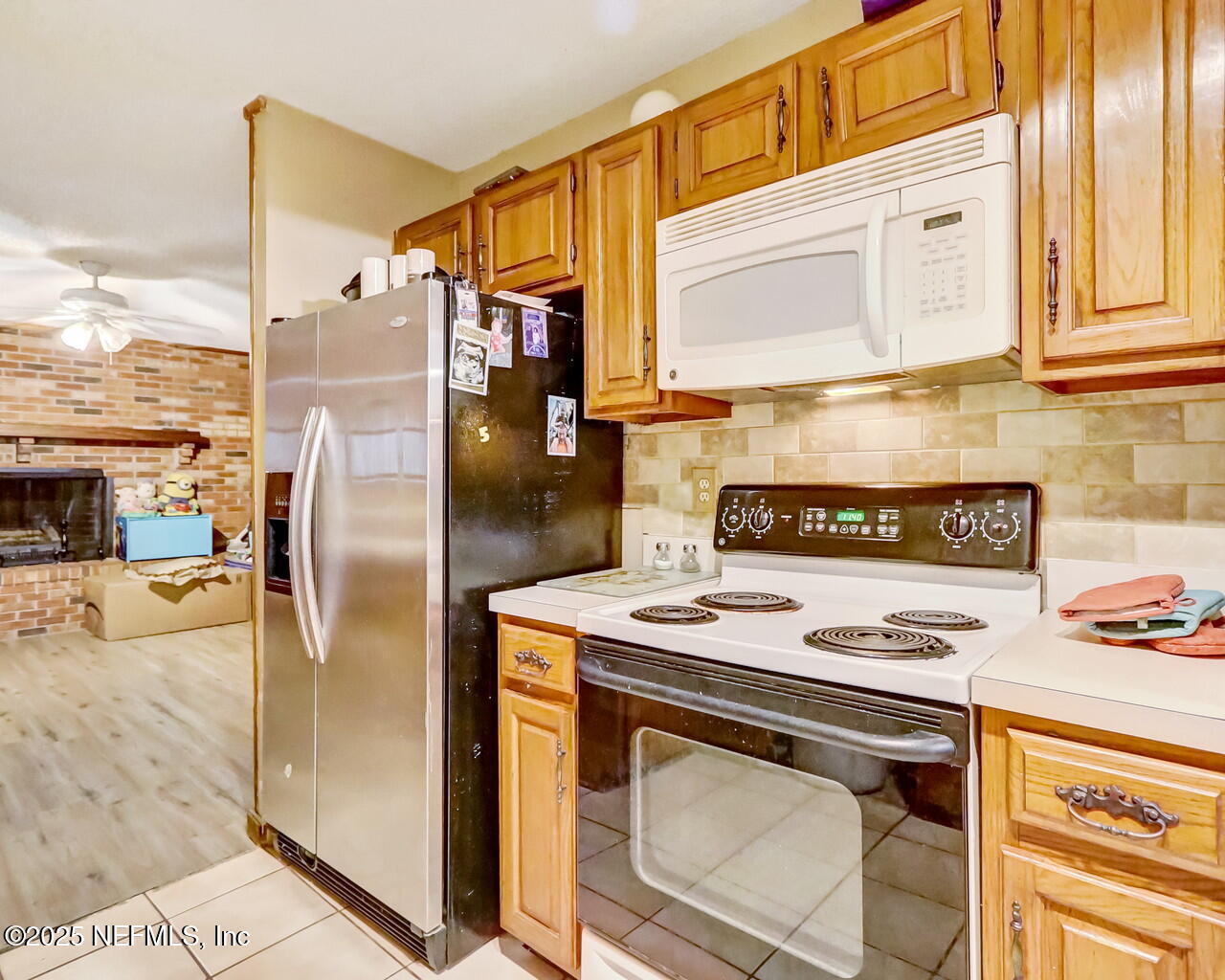43059 Pearl Lane Callahan, FL 32011 - Photo 14 of 42 a kitchen with stainless steel appliances granite countertop a stove a refrigerator and a cabinets