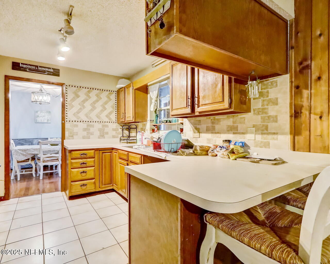 43059 Pearl Lane Callahan, FL 32011 - Photo 15 of 42 a kitchen with a sink a stove and chairs