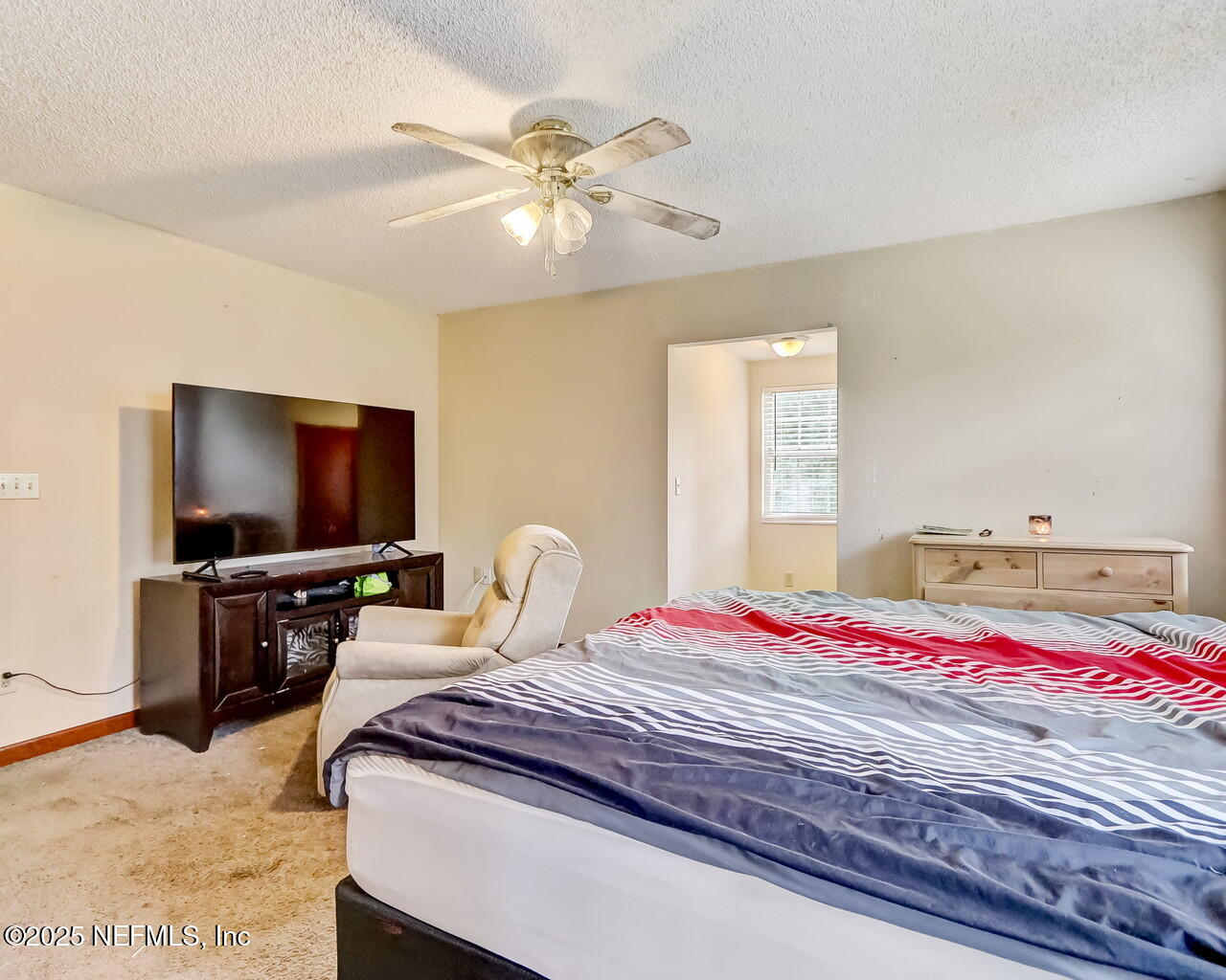 43059 Pearl Lane Callahan, FL 32011 - Photo 20 of 42 a bedroom with a bed and a flat screen tv