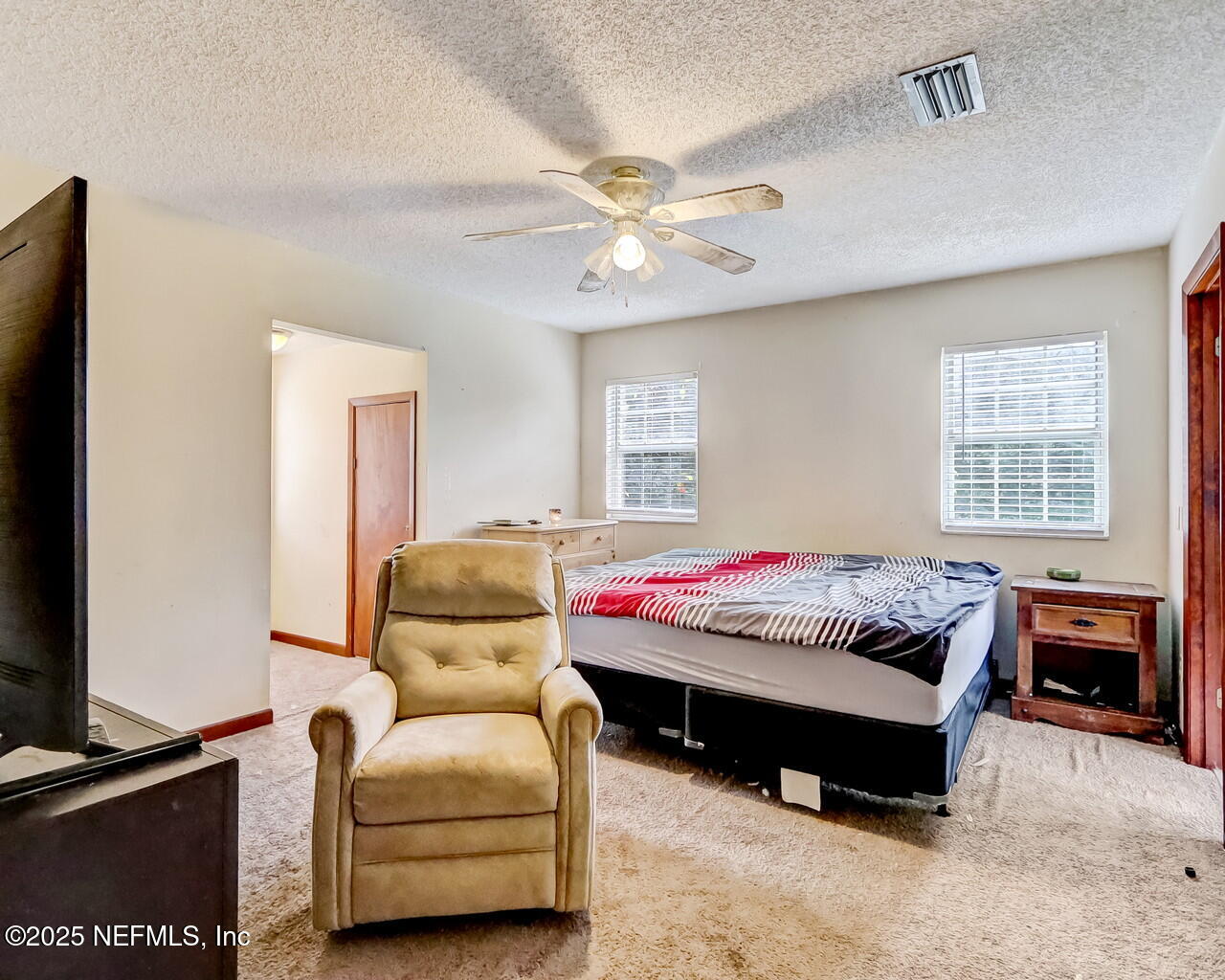 43059 Pearl Lane Callahan, FL 32011 - Photo 22 of 42 a bedroom with a bed and a chandelier