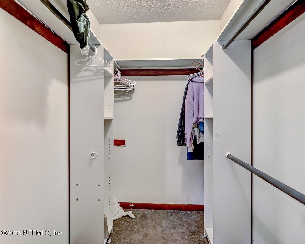 43059 Pearl Lane Callahan, FL 32011 - Photo 23 of 42 a view of walk in closet with clothes and shoes