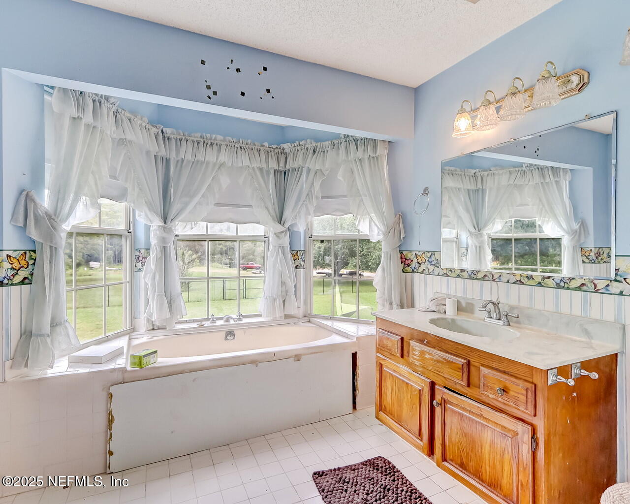 43059 Pearl Lane Callahan, FL 32011 - Photo 24 of 42 a large spacious bathroom with a large tub and sink