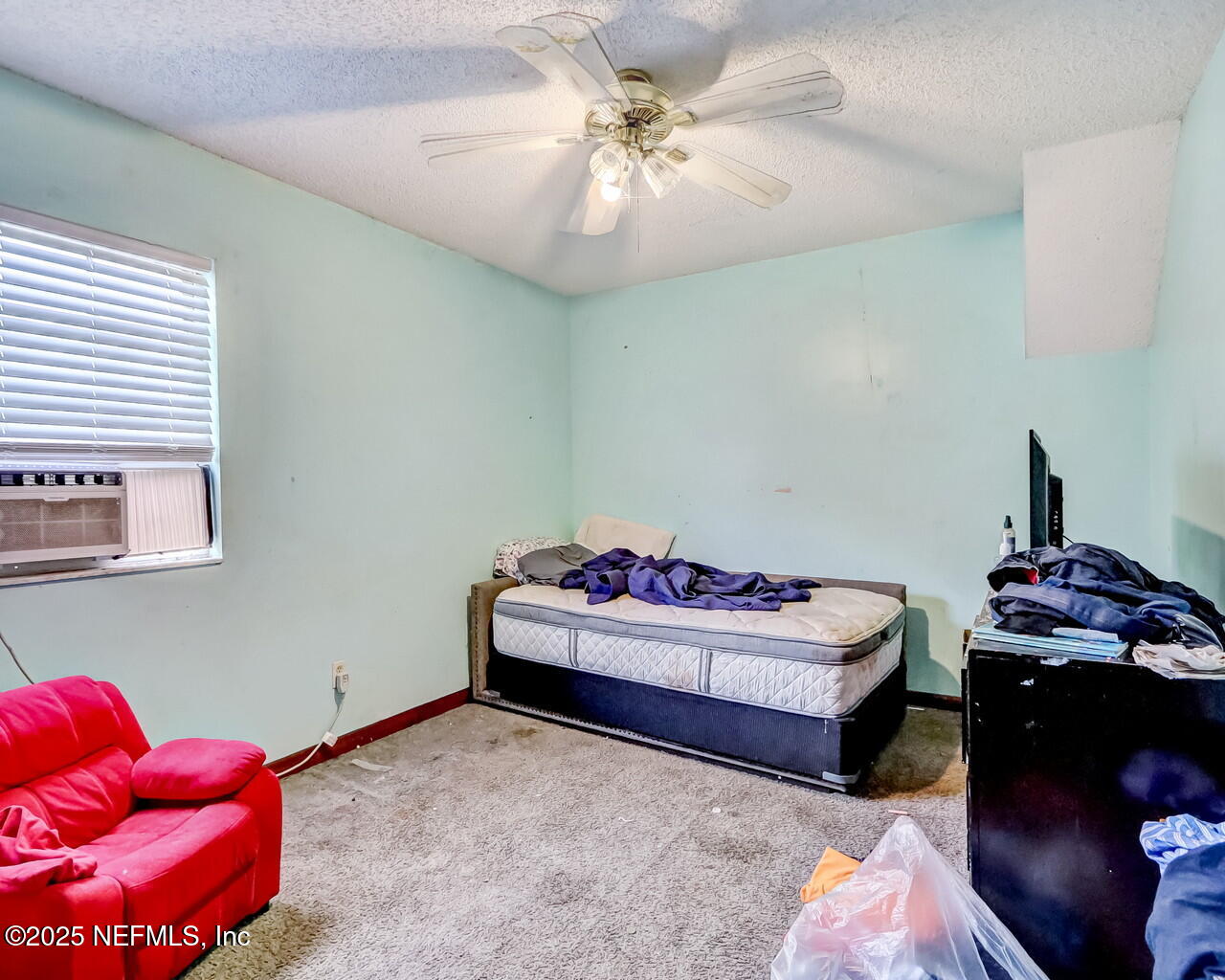 43059 Pearl Lane Callahan, FL 32011 - Photo 26 of 42 a bedroom with a bed and a chandelier
