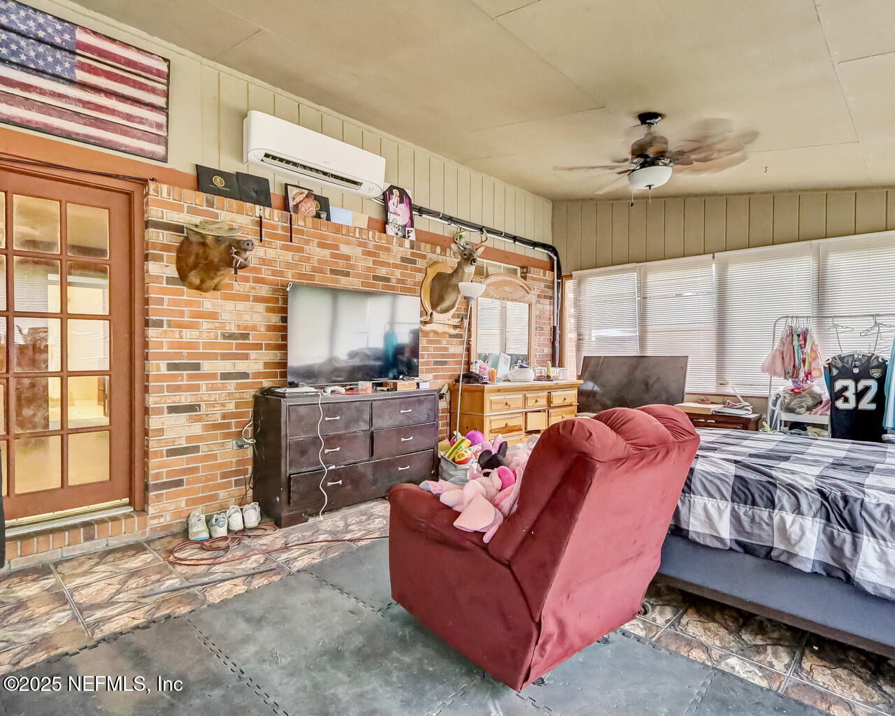43059 Pearl Lane Callahan, FL 32011 - Photo 32 of 42 a living room with furniture ceiling fan and a window