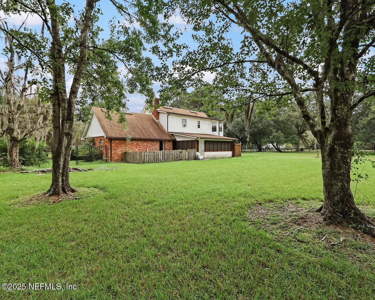 43059 Pearl Lane Callahan, FL 32011 - Photo 35 of 42 a view of a house with a big yard and large trees