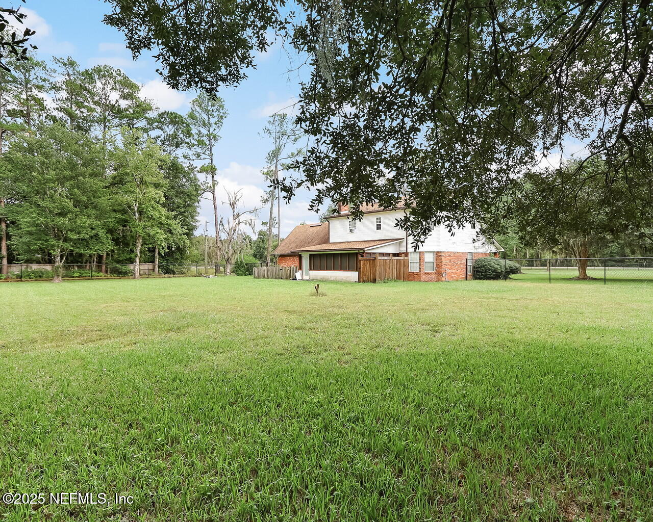 43059 Pearl Lane Callahan, FL 32011 - Photo 36 of 42 a front view of a house with yard and green space