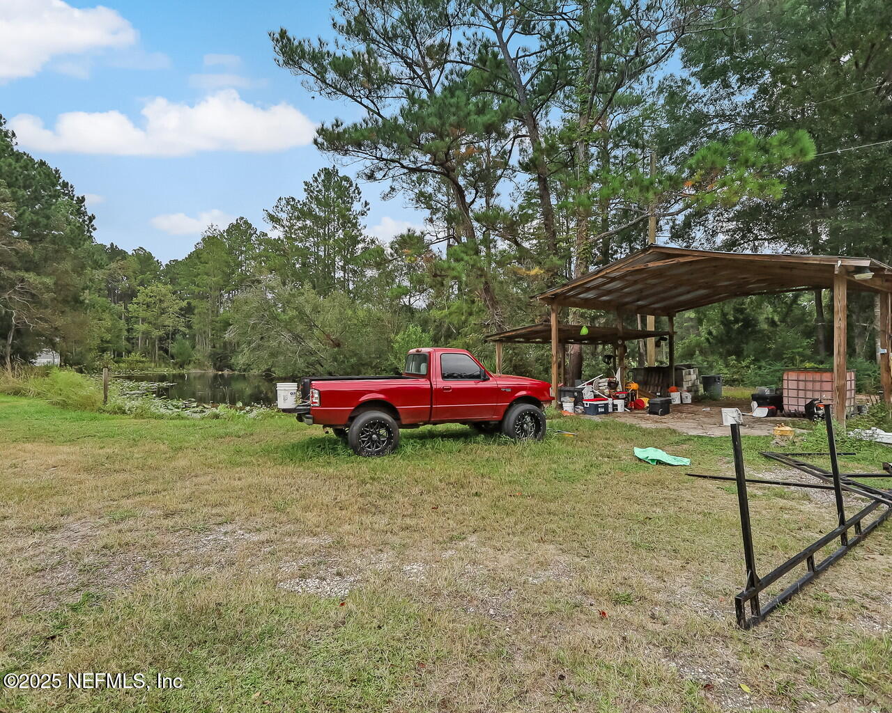 43059 Pearl Lane Callahan, FL 32011 - Photo 37 of 42 a view of a backyard with table and chairs under an umbrella