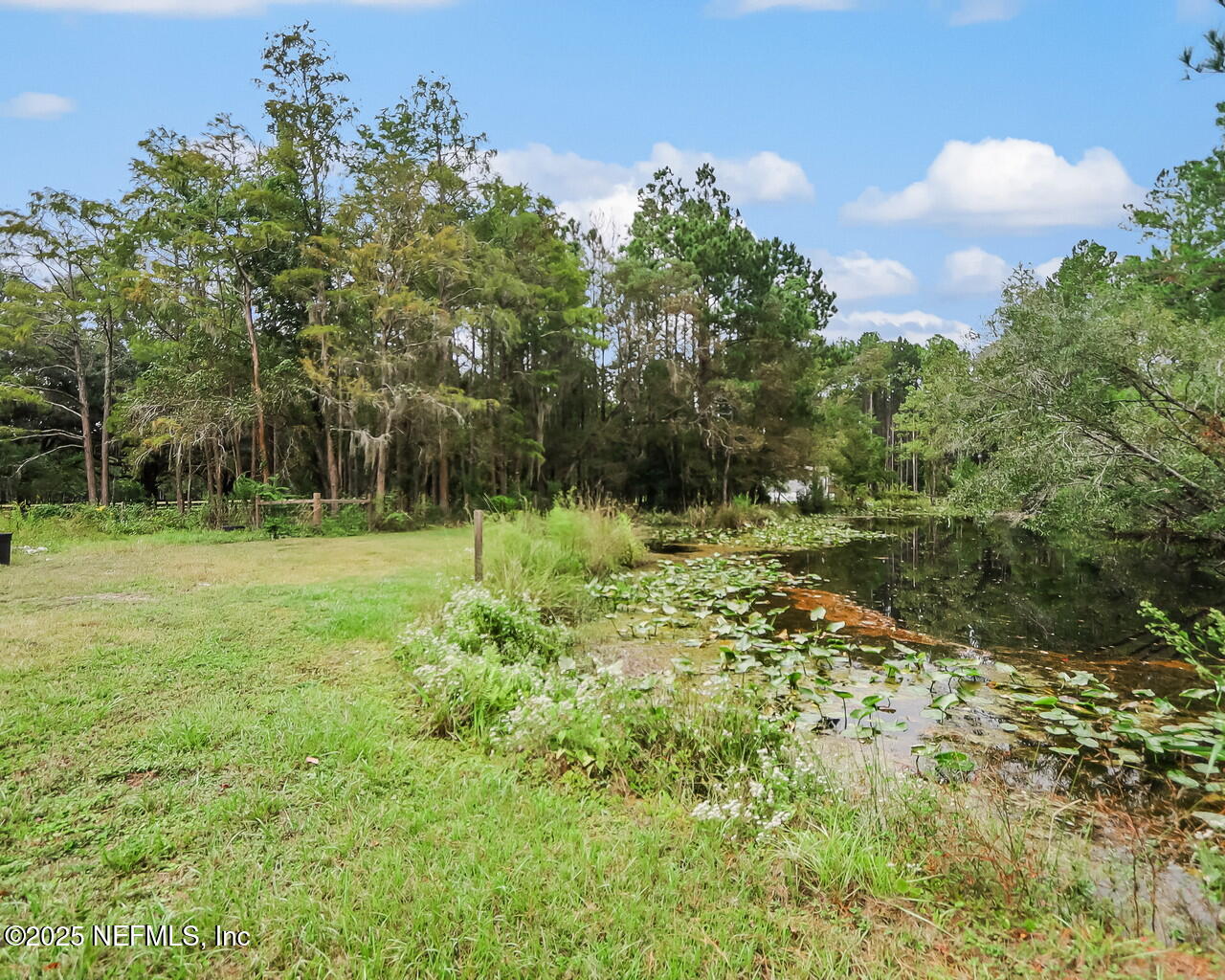 43059 Pearl Lane Callahan, FL 32011 - Photo 40 of 42 a view of outdoor space with deck and yard