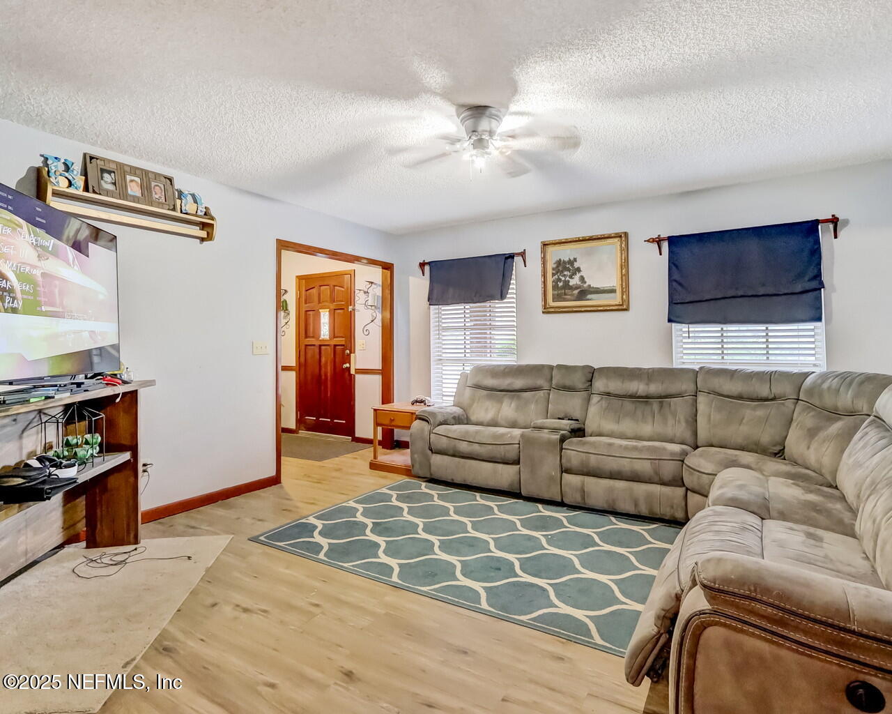43059 Pearl Lane Callahan, FL 32011 - Photo 9 of 42 a living room with furniture and a flat screen tv