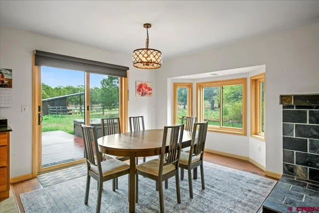a view of a dining room with furniture wooden floor and chandelier