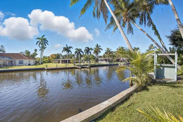 a view of a lake with boats and trees in the background