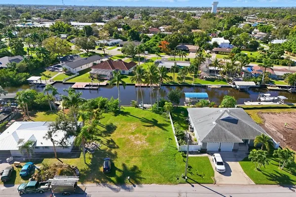 an aerial view of residential houses with outdoor space and swimming pool