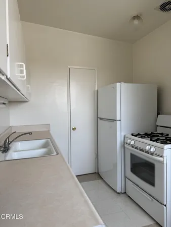 a kitchen with a stove and a refrigerator