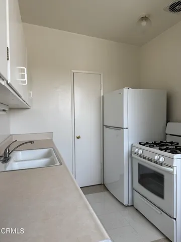 a kitchen with a stove and a refrigerator