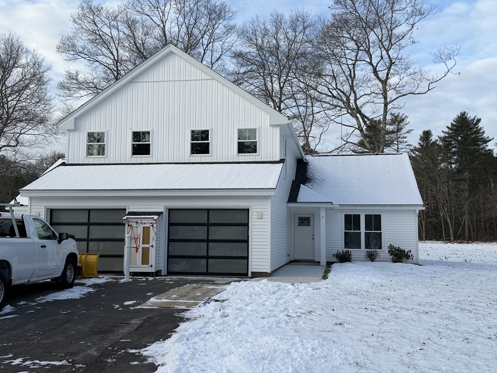 22 Barracks Road, Unit 22 Hudson, MA 01749 - Photo 1 of 15 a view of a white house with a large space and large trees