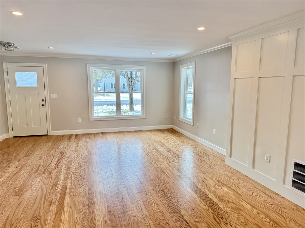 22 Barracks Road, Unit 22 Hudson, MA 01749 - Photo 4 of 15 an empty room with wooden floor and windows