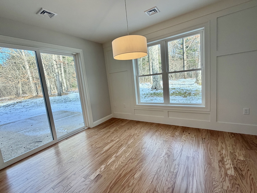 22 Barracks Road, Unit 22 Hudson, MA 01749 - Photo 5 of 15 a view of an empty room with wooden floor and a window