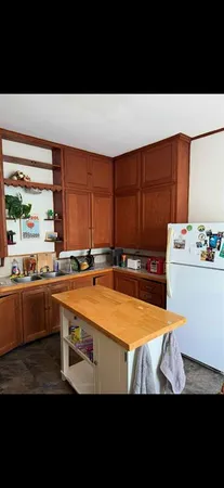 a kitchen with a table chairs and wooden floor