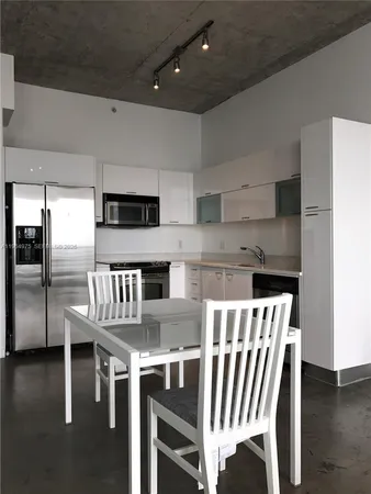 a stove top oven sitting inside of a kitchen