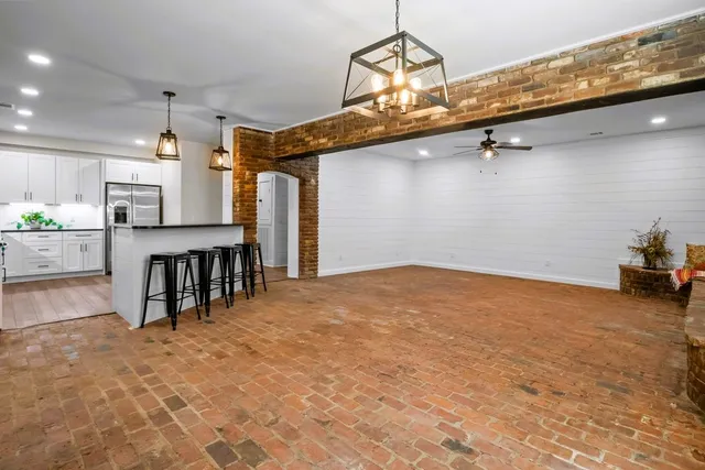 a view of a livingroom with a ceiling fan and window