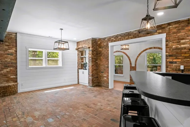 a kitchen with stainless steel appliances kitchen island granite countertop a stove a sink and a microwave