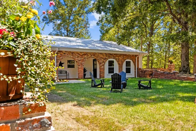 a view of a house with backyard porch and garden