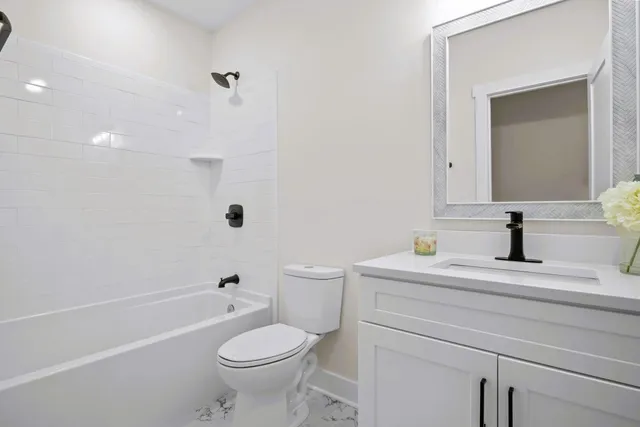 a hallway with a wooden floor and a kitchen