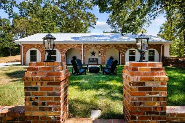a view of swimming pool with garden and bench