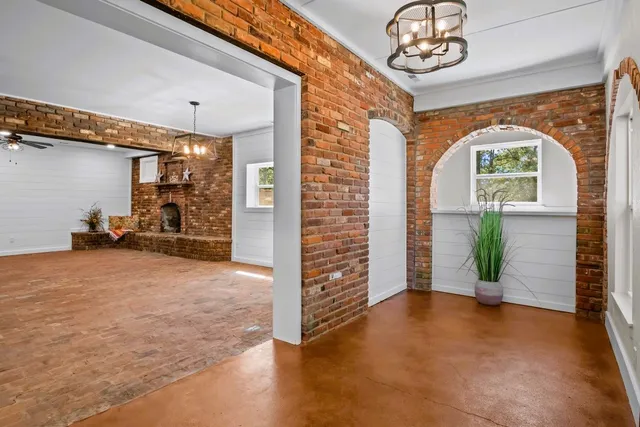 a view of livingroom with workspace and windows