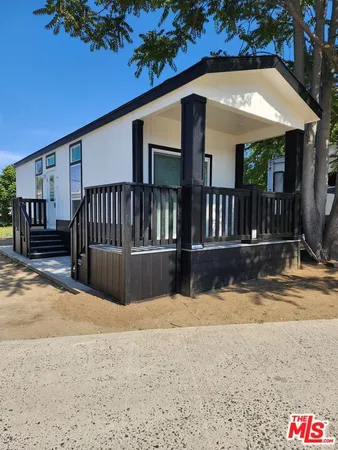 a view of house with outdoor space and sitting area