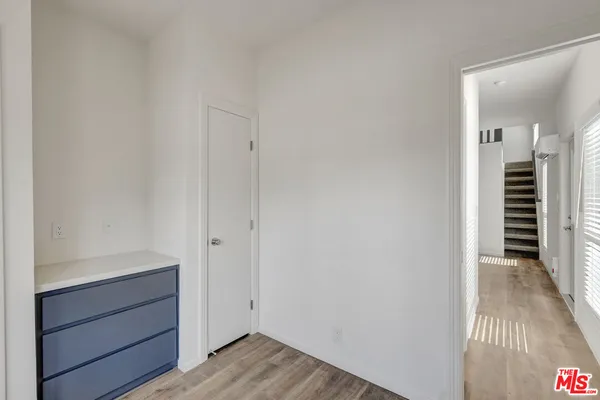a view of hallway with stairs and wooden floor