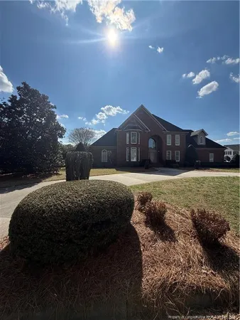 a view of a house with a yard and a garden