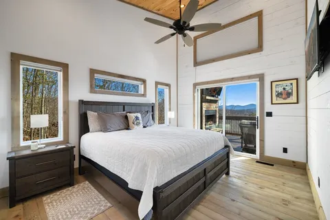 a bedroom with a large bed and a chandelier