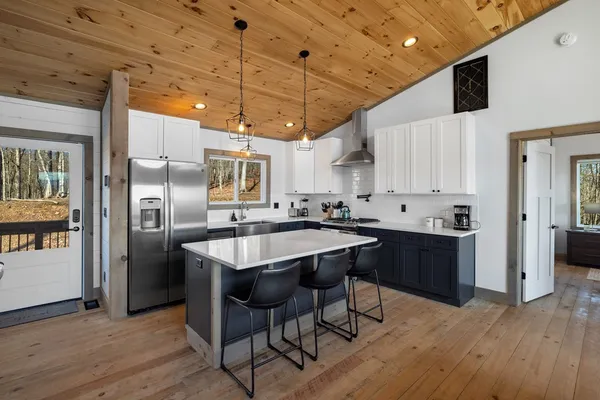 a kitchen with stainless steel appliances a sink a stove and cabinets