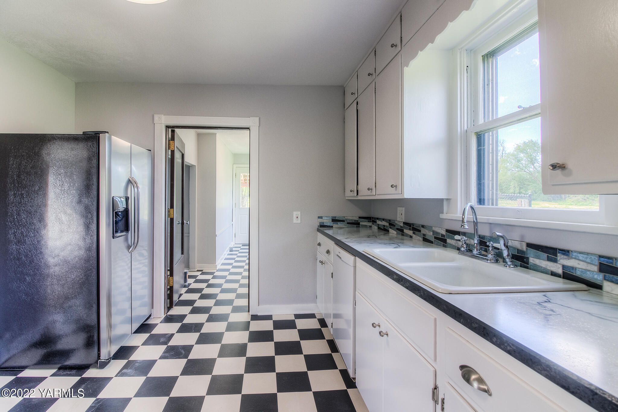 1212 Dazet Road Yakima, WA 98908 - Photo 7 of 37 a kitchen with a sink a refrigerator and cabinets