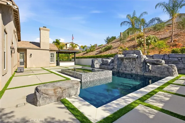 a living room with chairs and a table