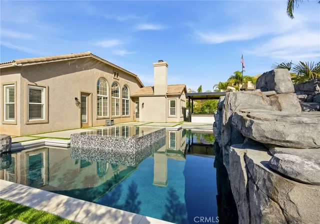 a front view of a house with outdoor seating