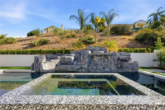 a view of a swimming pool with a yard