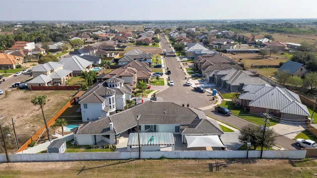 an aerial view of residential houses with outdoor space and swimming pool