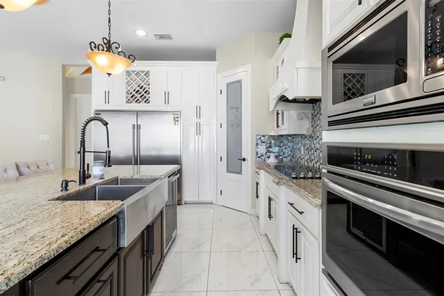 a kitchen with stainless steel appliances granite countertop a sink and stove
