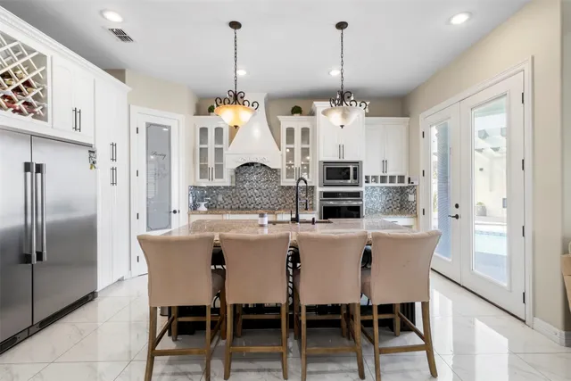 a view of a dining room and livingroom with furniture wooden floor a chandelier