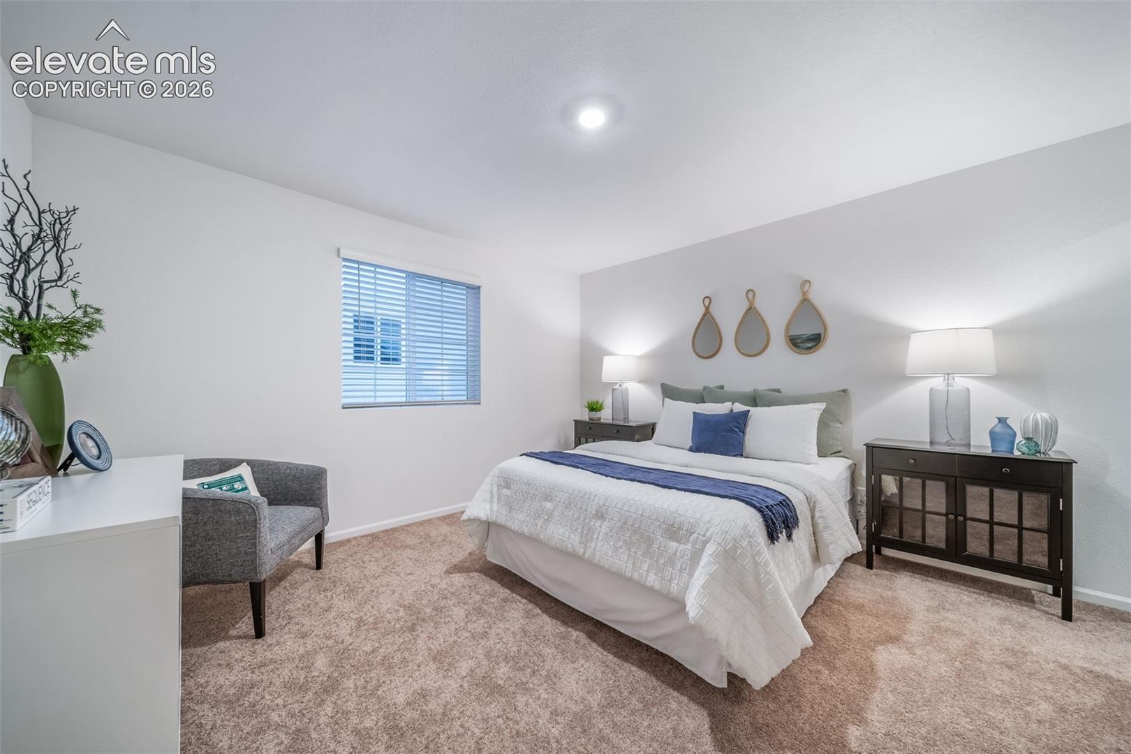 4936 Truscott Road Colorado Springs, CO 80925 - Photo 7 of 41 Plush carpeted flooring, window with blinds, recessed ceiling light, and built-in lighting
*photos of a model home*