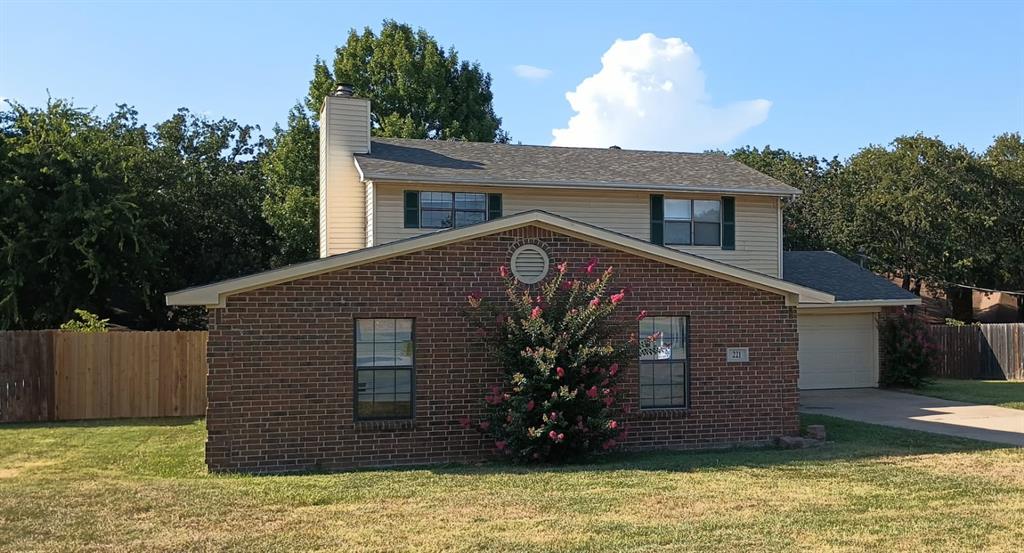 a house that has a tree in front of it