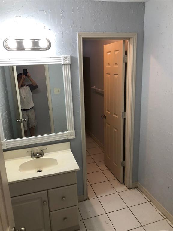 221 Addison Street Lake Dallas, TX 75065 - Photo 4 of 13 a bathroom with a sink a toilet and mirror
